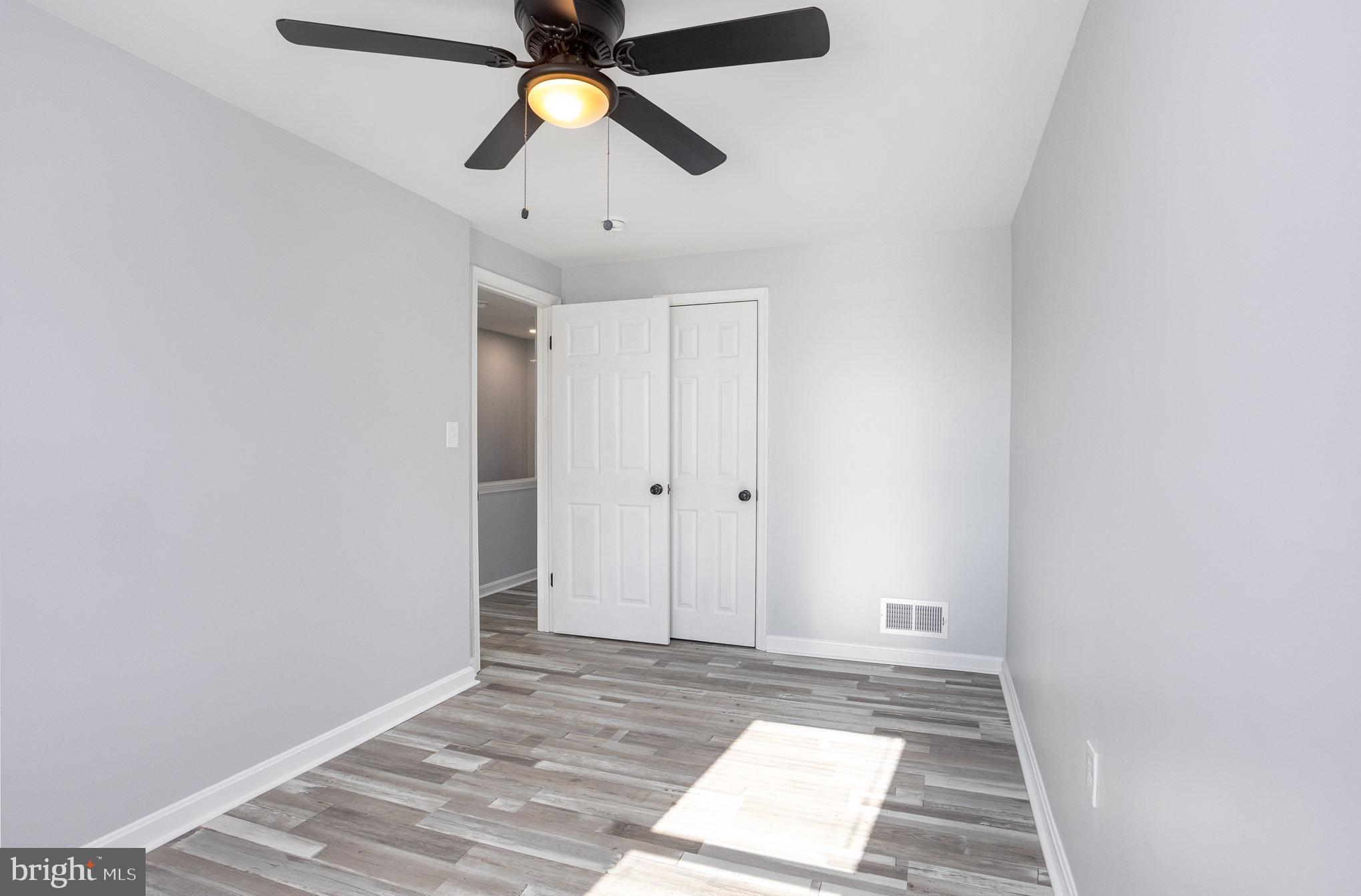 2070 Larkhall Road Dundalk, MD 21222 - Photo 10 of 26 an empty room with closet and a chandelier fan