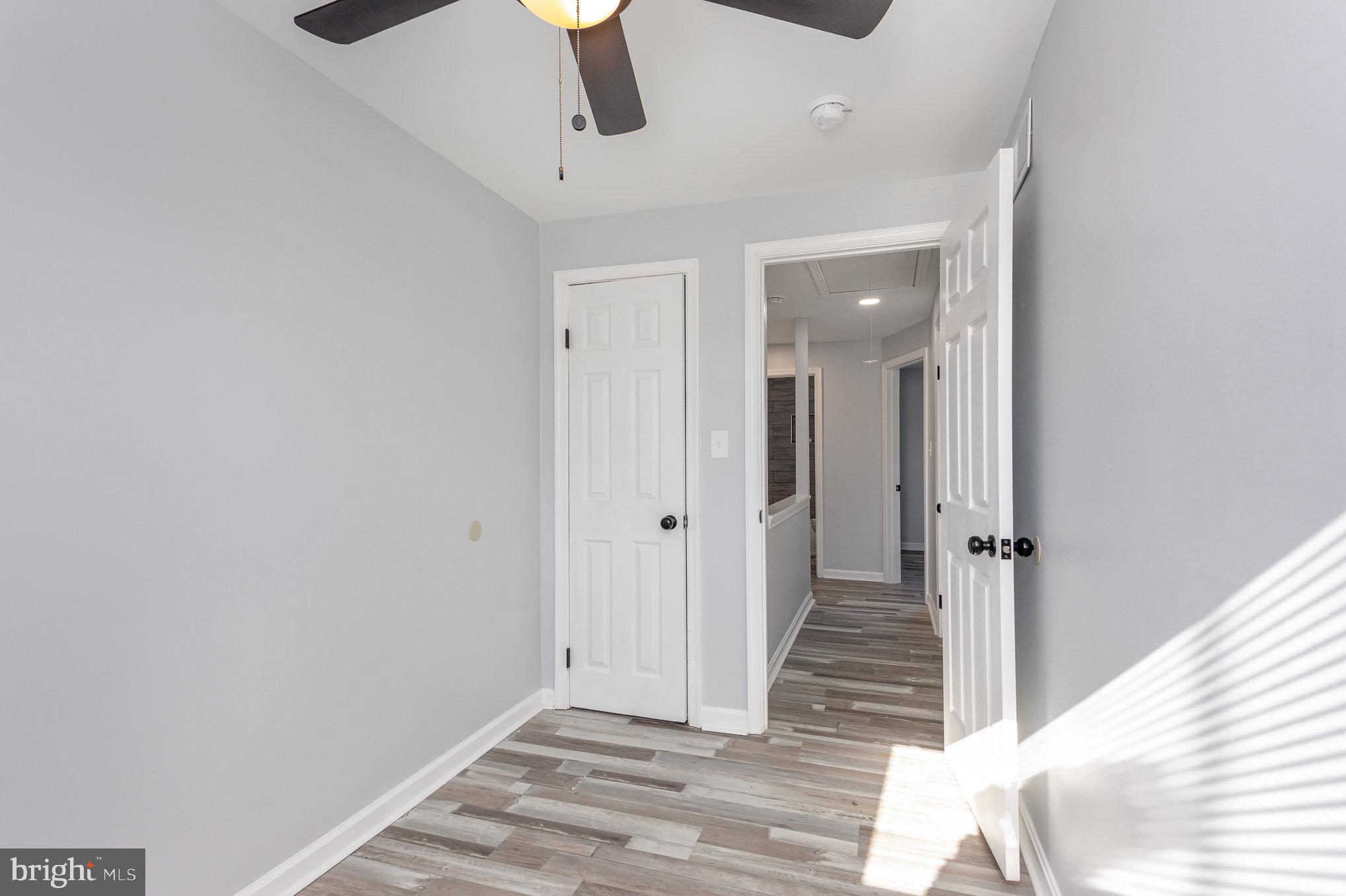 2070 Larkhall Road Dundalk, MD 21222 - Photo 14 of 26 a view of a hallway with wooden floor and staircase