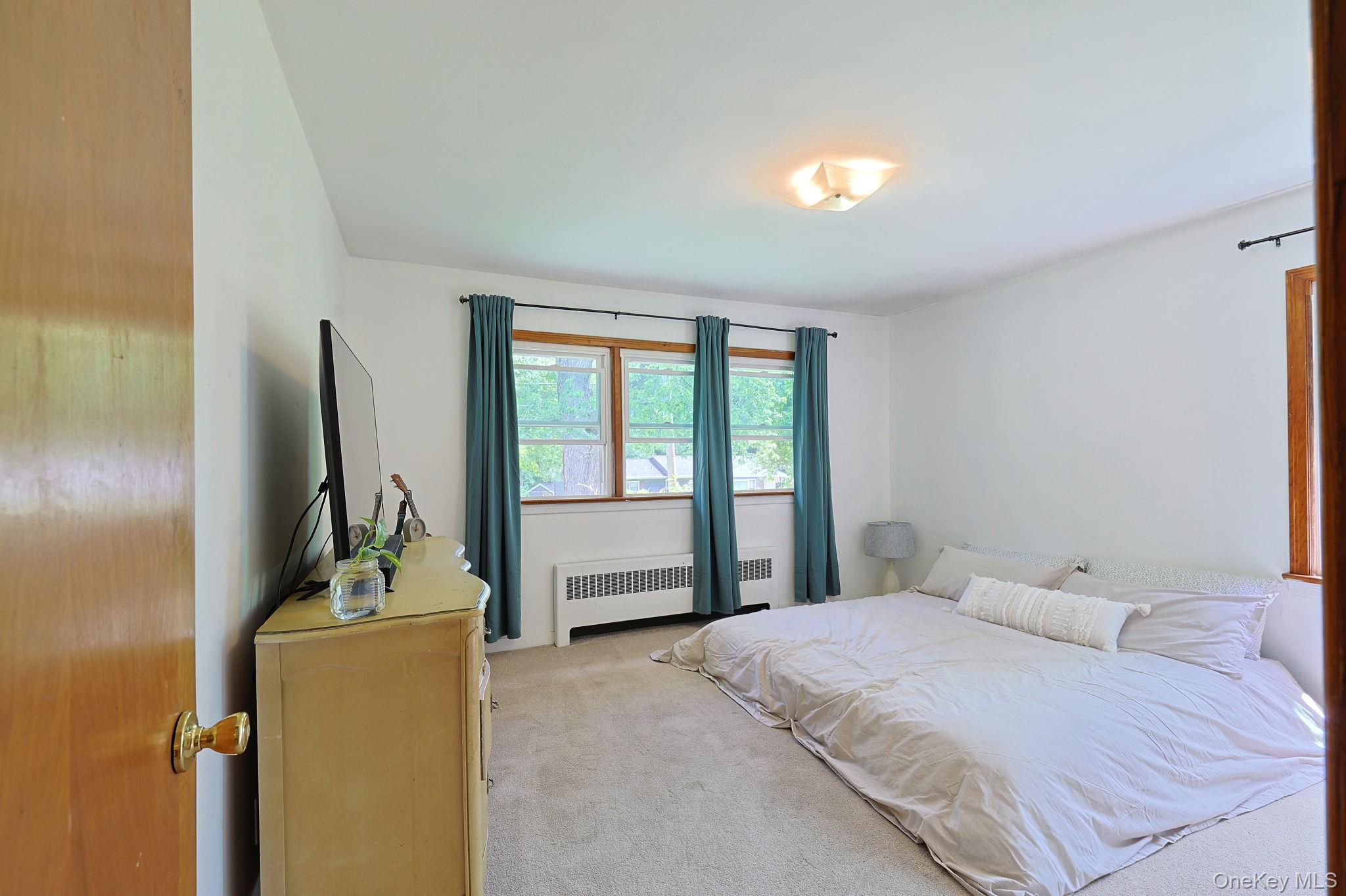 178 Mt Airy Road New Windsor, NY 12553 - Photo 11 of 31 a bedroom with a bed and a flat tv screen on dresser