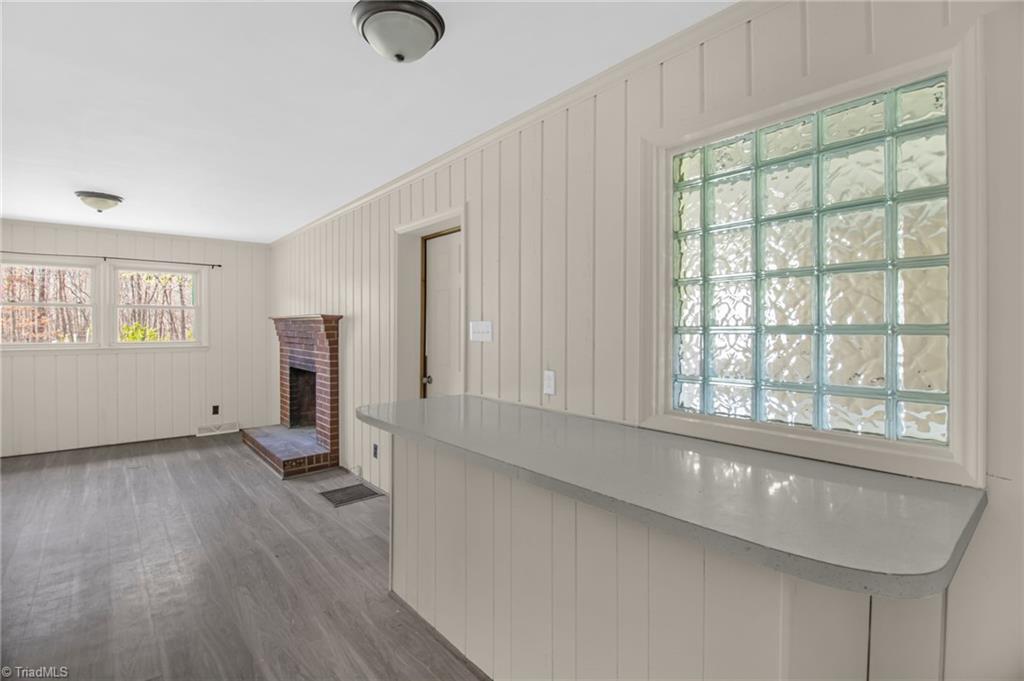 8225 Easley Road Walnut Cove, NC 27052 - Photo 13 of 33 Kitchen bar looking into dining room or den. Stylish glass blocked window.