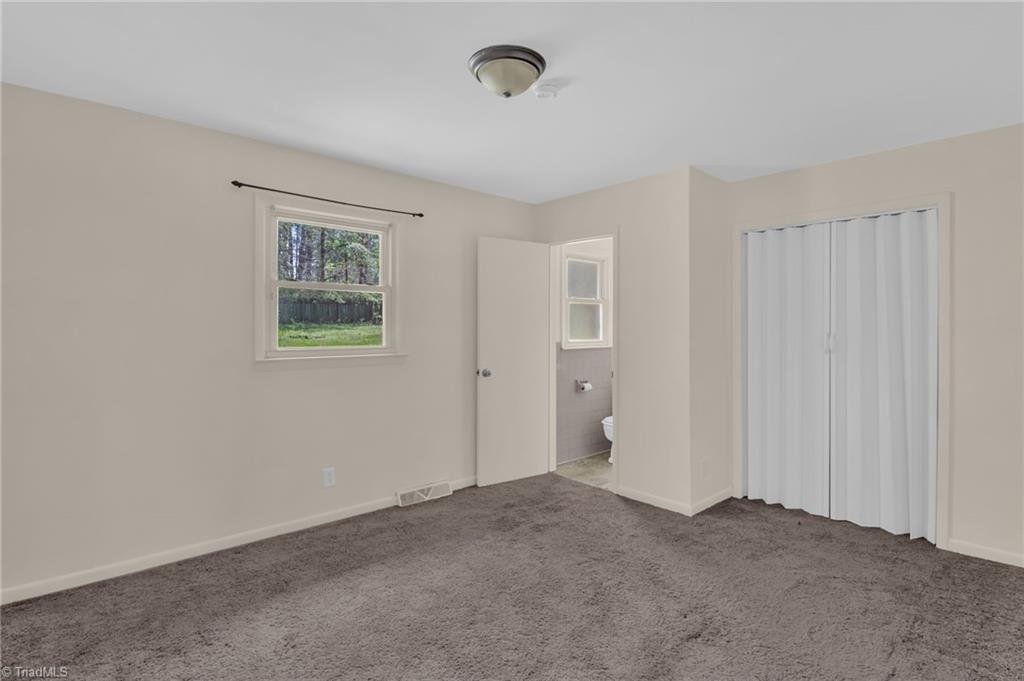 8225 Easley Road Walnut Cove, NC 27052 - Photo 17 of 33 Primary bedroom with ensuite half bath.