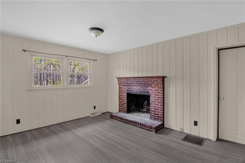 8225 Easley Road Walnut Cove, NC 27052 - Photo 10 of 33 Real wood paneling surrounds the room and fireplace