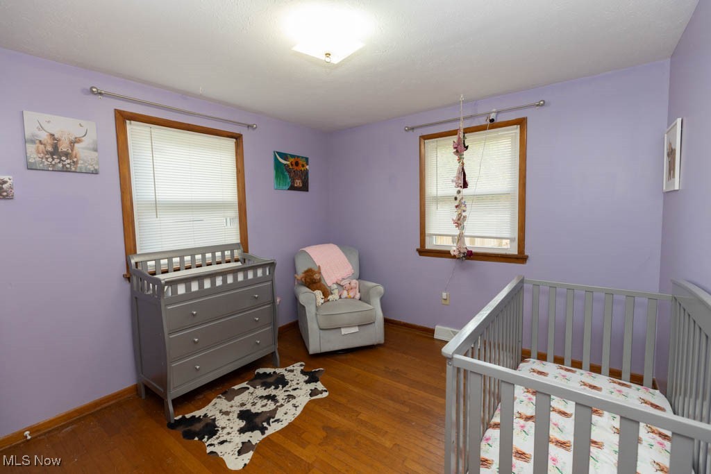 1085 Novak Road Grafton, OH 44044 - Photo 19 of 41 Bedroom featuring a crib and wood finished floors