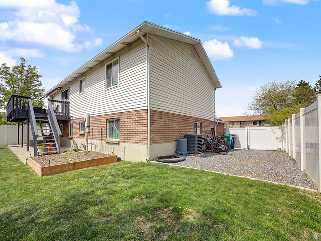 523 Mountain View Road Centerville, UT 84014 - Photo 25 of 33 Rear view of property featuring a fenced backyard, brick siding, and a wooden deck