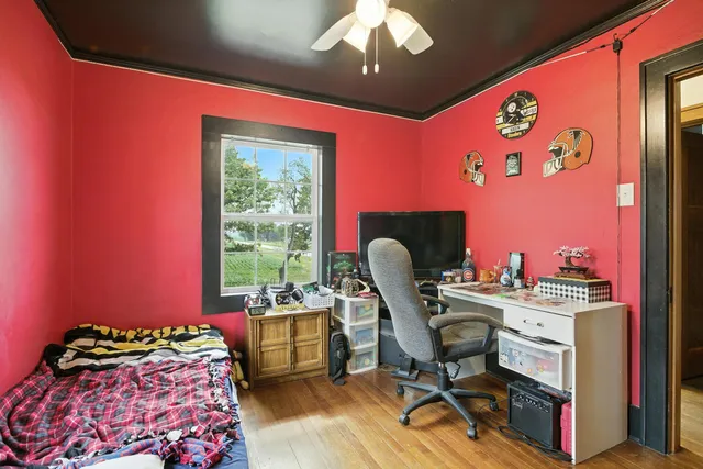 a bedroom with furniture and a large window