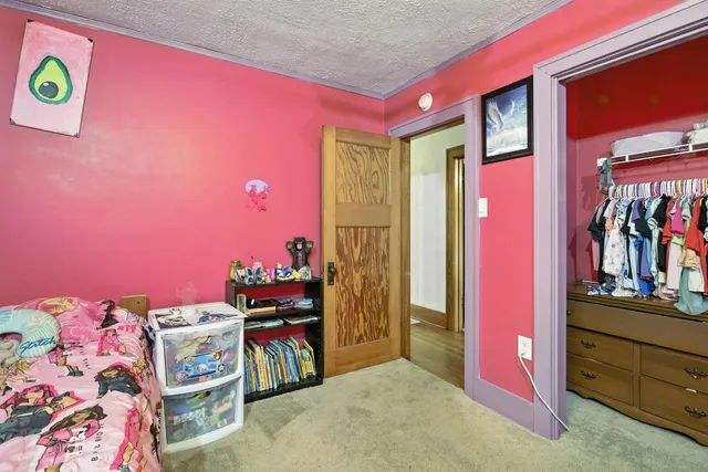 a bedroom with bed and a chandelier