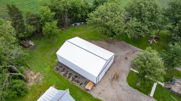 an aerial view of a house with a yard and lake view