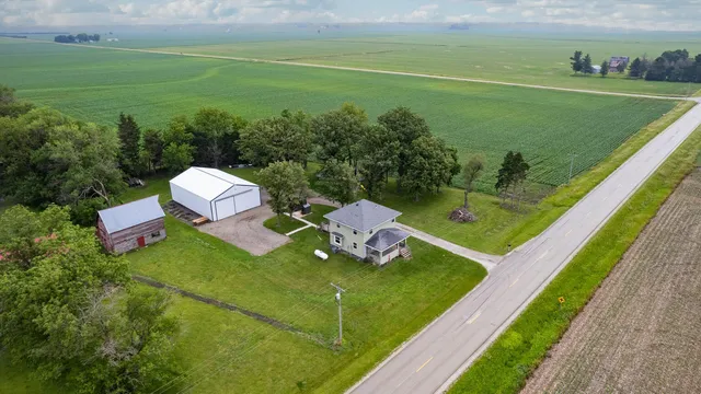 a view of a table and chairs in the garden