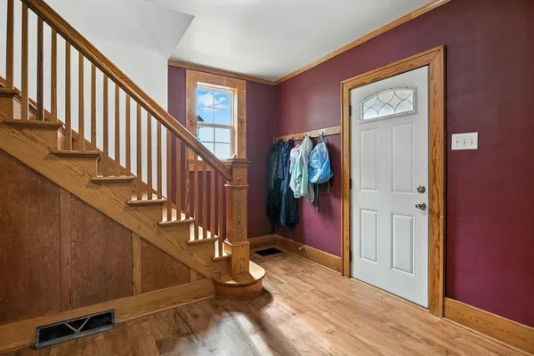 a view of an entryway with wooden floor and stairs