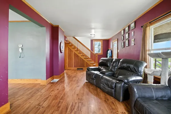 a living room with furniture and a wooden floor