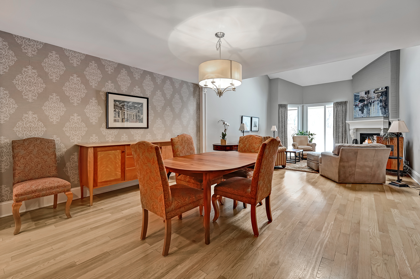 1208 Indian Trail Road, Unit 3E Hinsdale, IL 60521 - Photo 5 of 24 a dining room with wooden floor a chandelier a wooden table and chairs