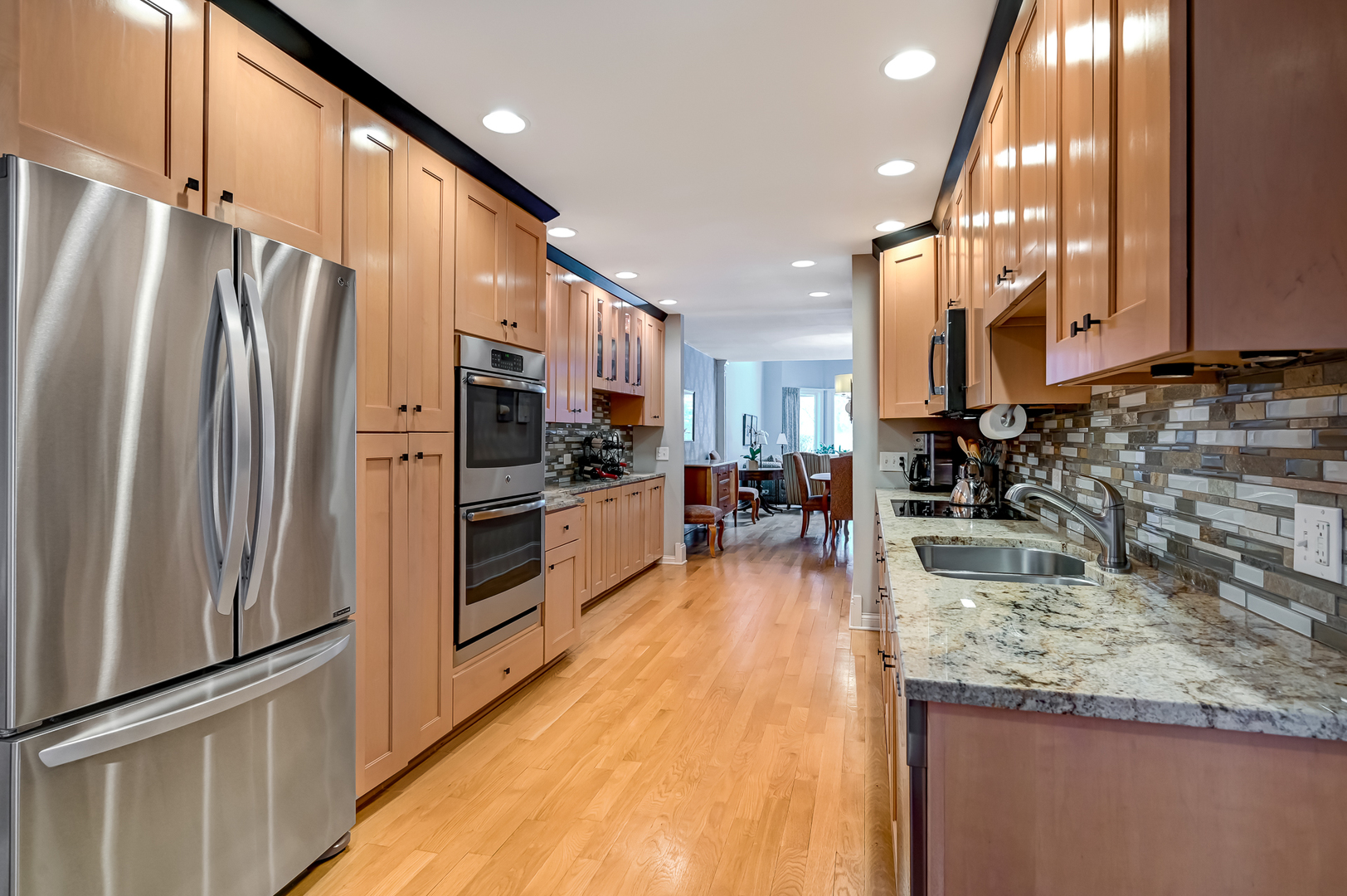 1208 Indian Trail Road, Unit 3E Hinsdale, IL 60521 - Photo 6 of 24 a kitchen with stainless steel appliances granite countertop a refrigerator a stove and a sink