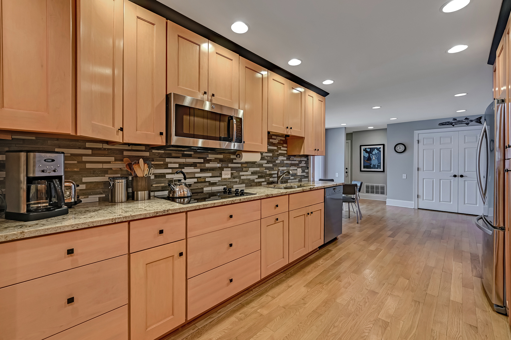 1208 Indian Trail Road, Unit 3E Hinsdale, IL 60521 - Photo 7 of 24 a large kitchen with stainless steel appliances granite countertop a stove a sink dishwasher and a microwave oven with white cabinets