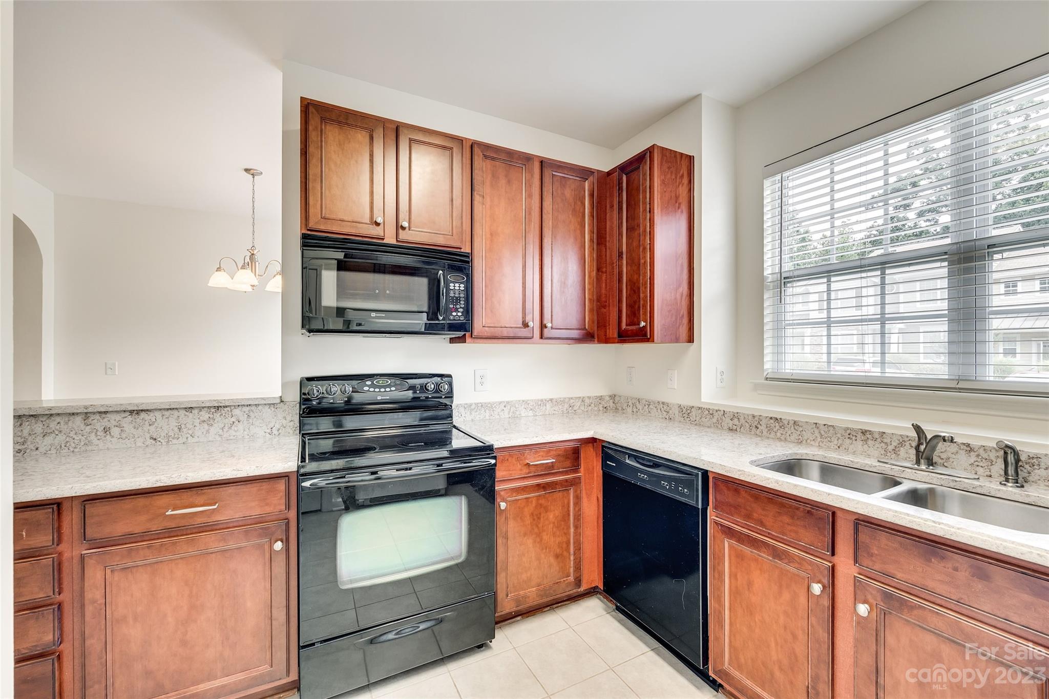 958 Copperstone Lane Fort Mill, SC 29708 - Photo 14 of 29 a kitchen with granite countertop wooden cabinets stove top oven and sink