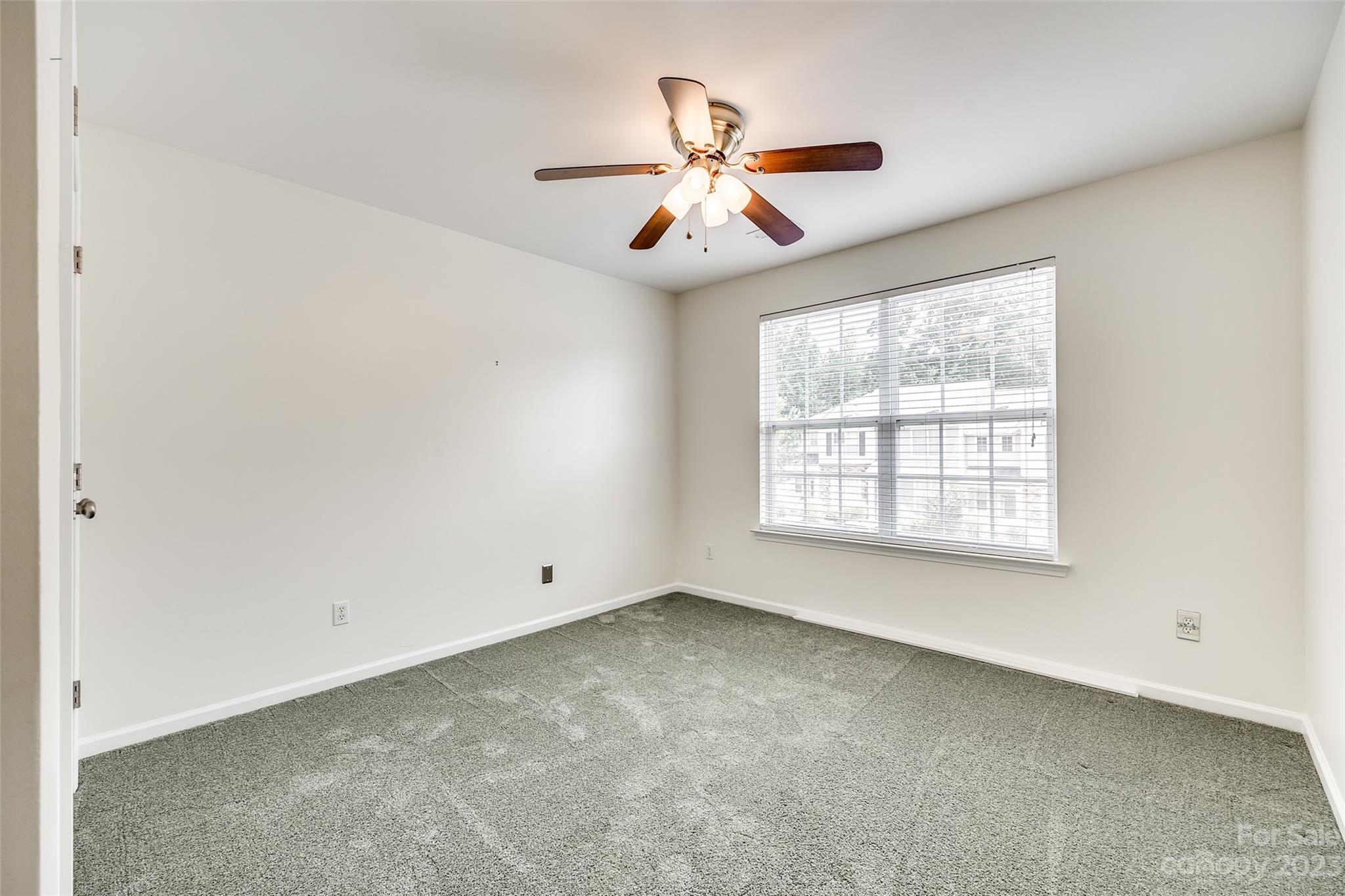 958 Copperstone Lane Fort Mill, SC 29708 - Photo 21 of 29 a view of an empty room with chandelier fan and fire place
