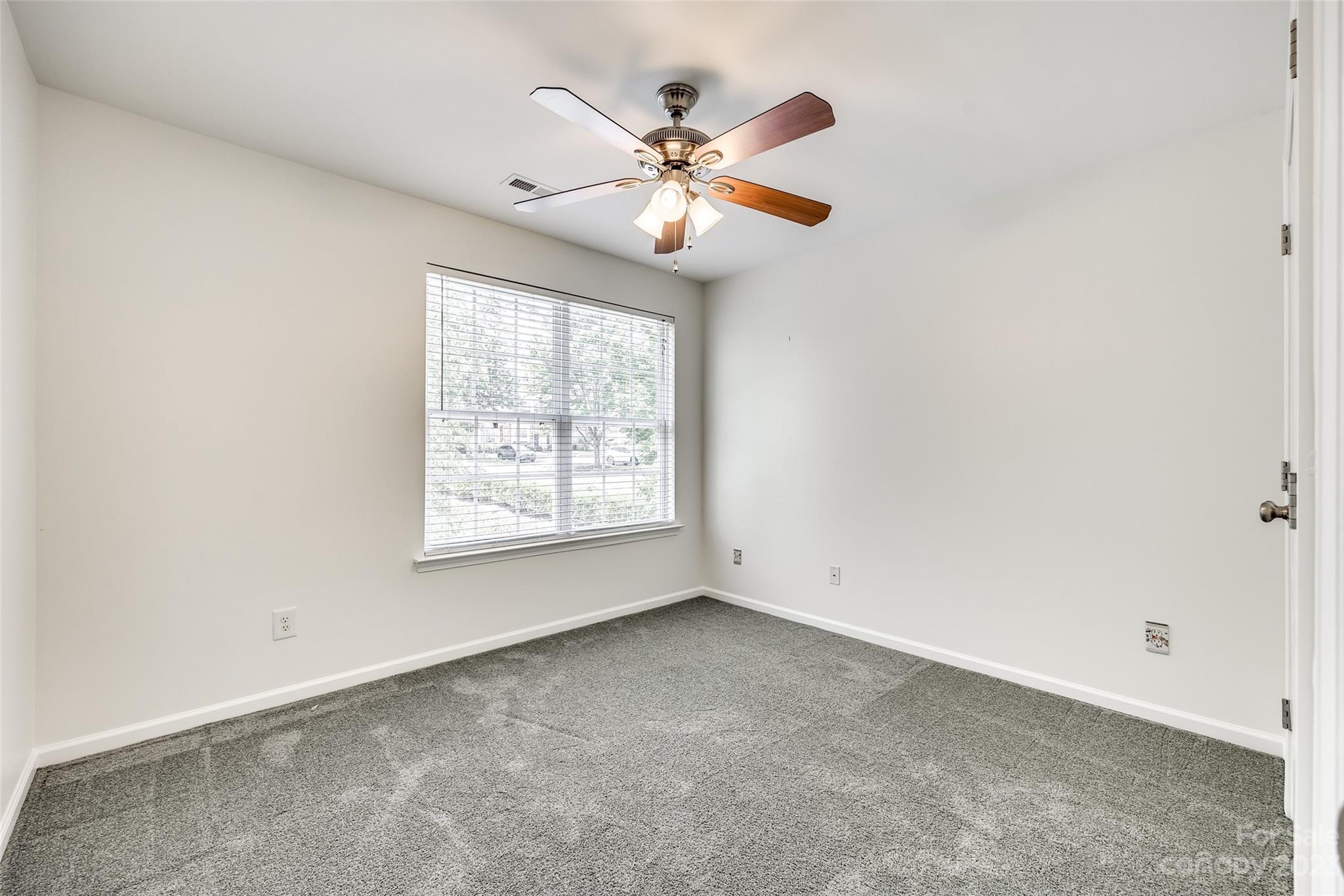 958 Copperstone Lane Fort Mill, SC 29708 - Photo 23 of 29 an empty room with windows and fan