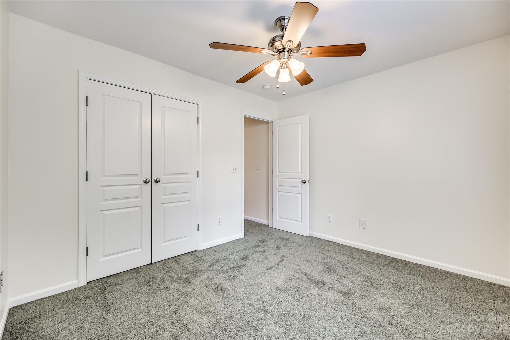 958 Copperstone Lane Fort Mill, SC 29708 - Photo 24 of 29 an empty room with a chandelier fan