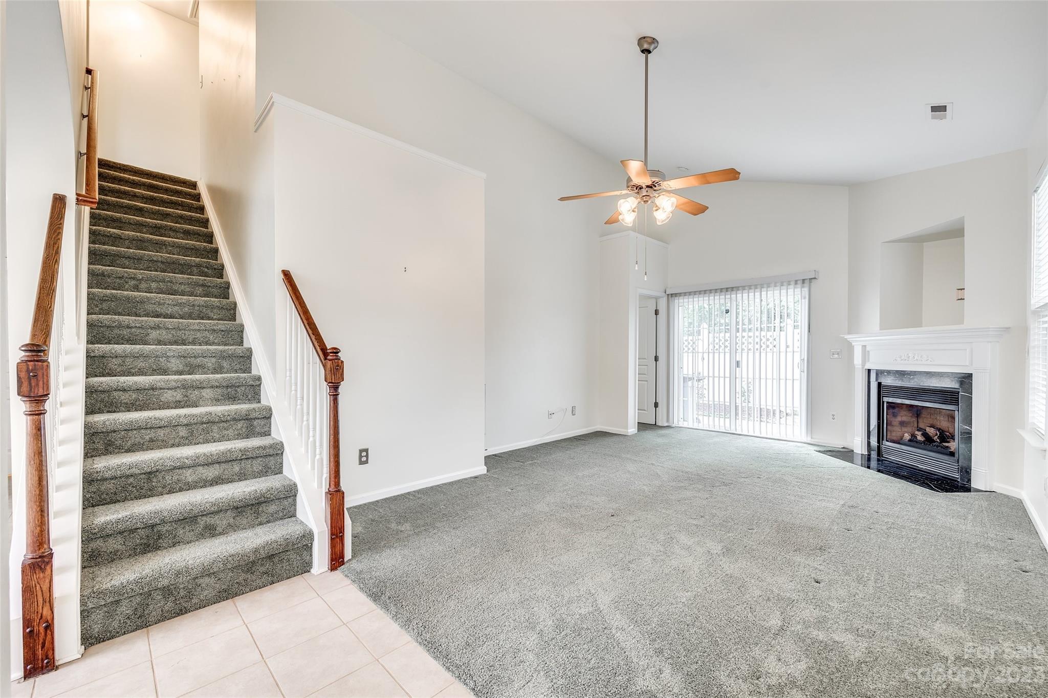 958 Copperstone Lane Fort Mill, SC 29708 - Photo 3 of 29 a view of an empty room with a fireplace chandelier and a window