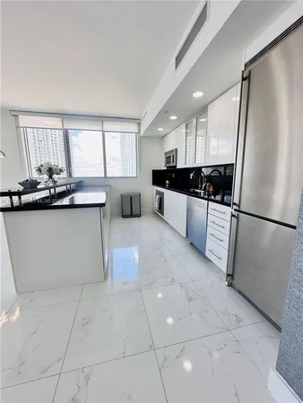 a kitchen with granite countertop a sink and cabinets
