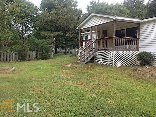 286 Stancil Road Ball Ground, GA 30107 - Photo 1 of 1 a front view of a house with a garden