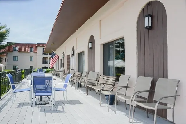 an outdoor space with patio furniture and wooden floor