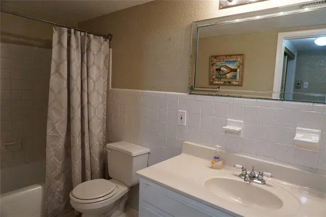 a bathroom with a sink toilet and mirror