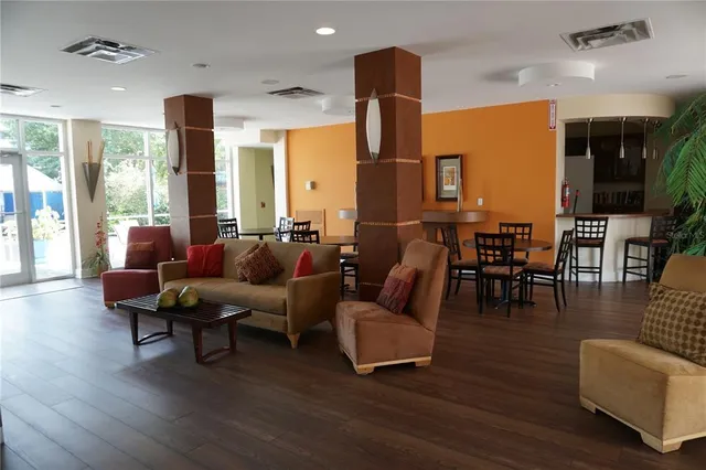 a living room with fireplace furniture and a wooden floor