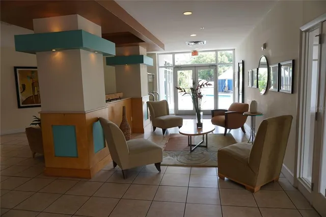 a living room with furniture and large windows