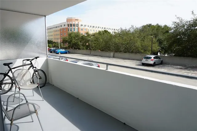 a view of a city street with a car parked on road