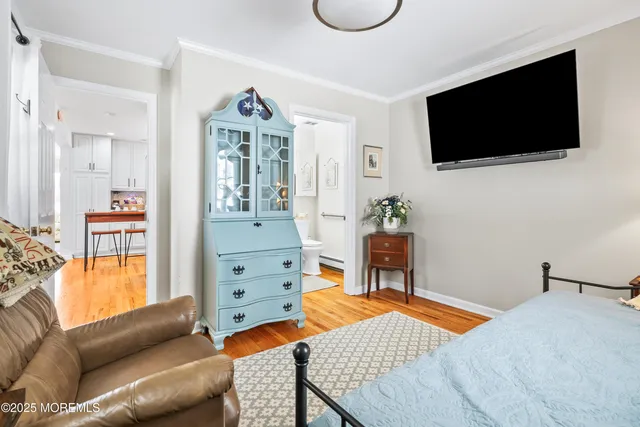 a bedroom with a bed and flat screen tv