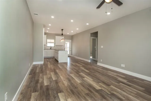 a view of a kitchen and an empty room