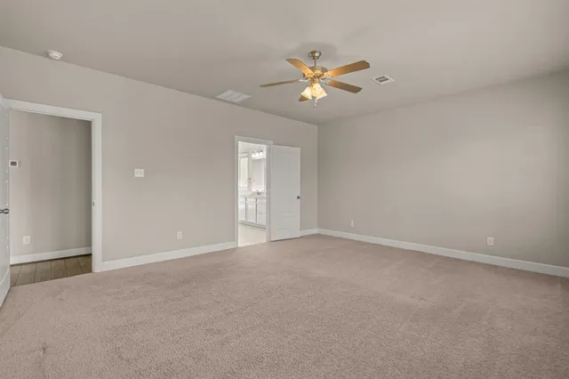 a view of an empty room with a fan