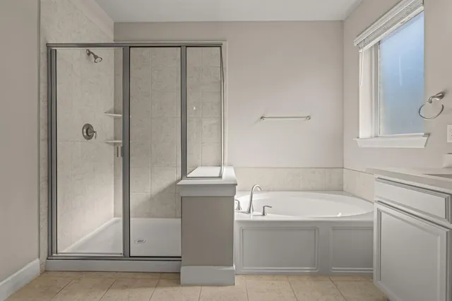 a bathroom with a bathtub and shower