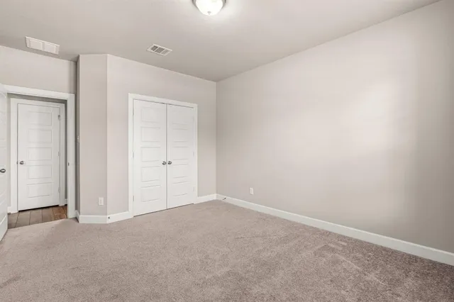 an empty room with closet area