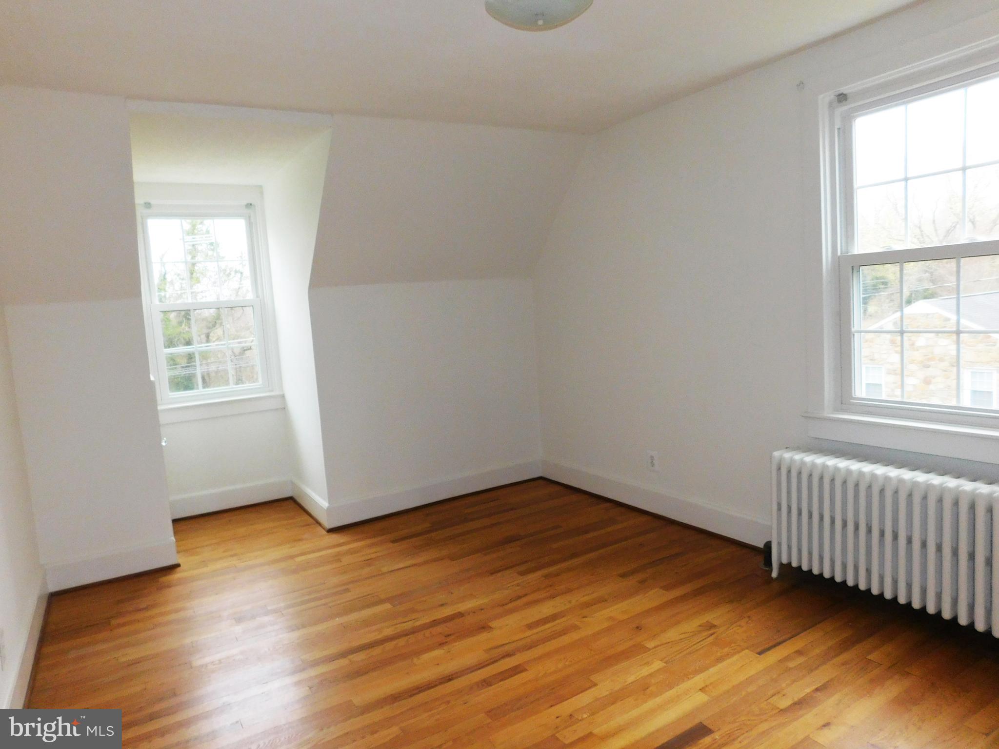 641 Old Meetze Road Warrenton, VA 20186 - Photo 11 of 15 an empty room with wooden floor and windows