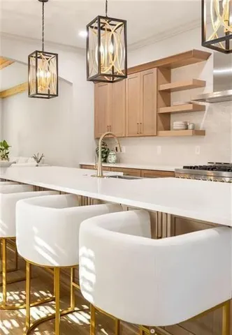 a kitchen with stainless steel appliances granite countertop a sink stove and wooden floor