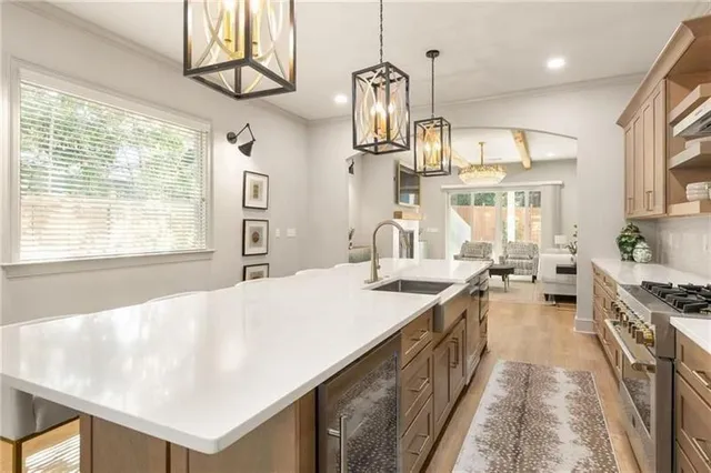 a living room with furniture a dining table and a chandelier