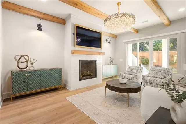 a bedroom with a large bed and a chandelier