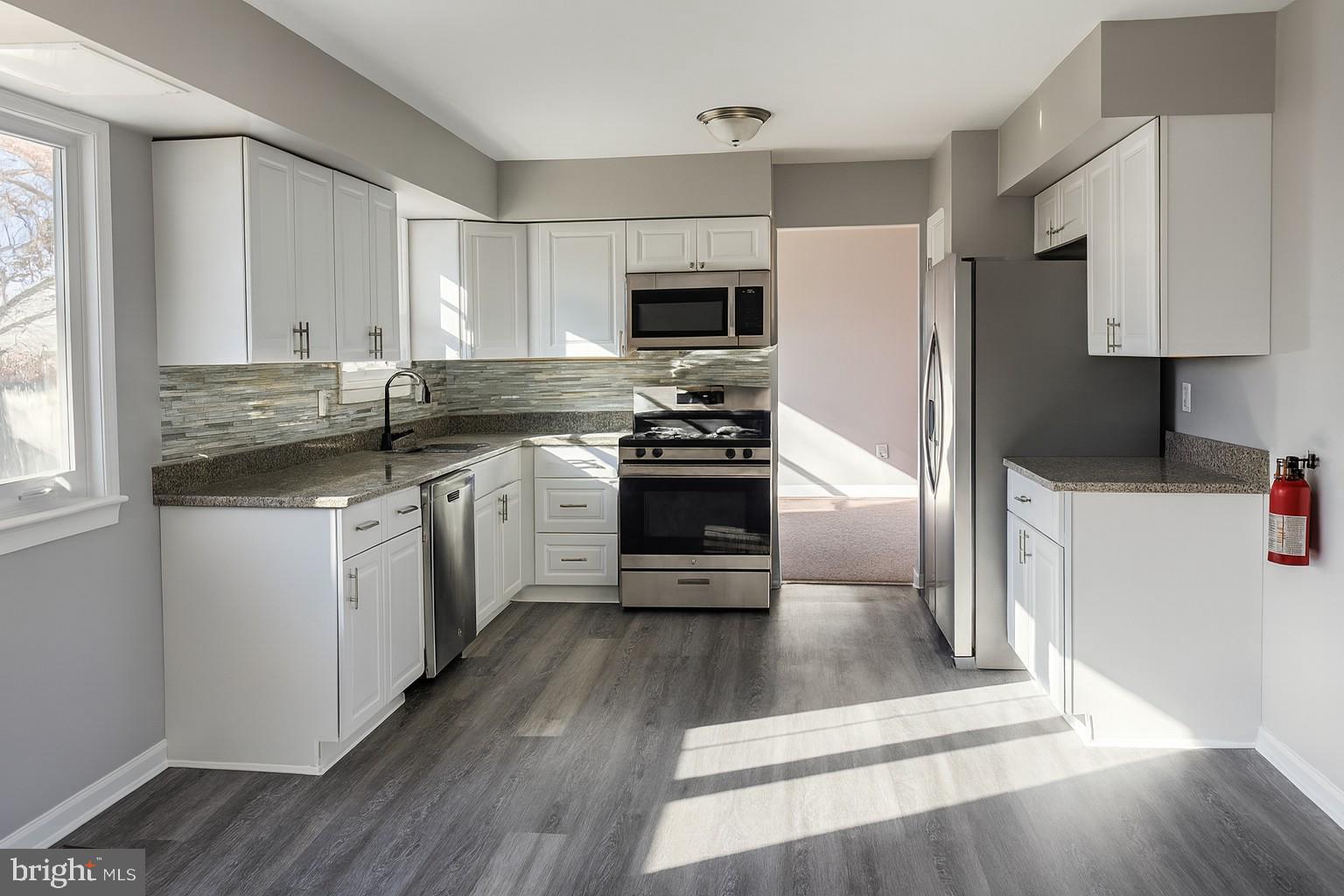 112 Hemlock Drive Williamstown, NJ 08094 - Photo 5 of 12 a kitchen with a sink a counter top space stainless steel appliances and a window