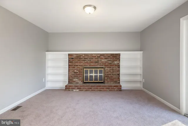 a view of empty room with fireplace