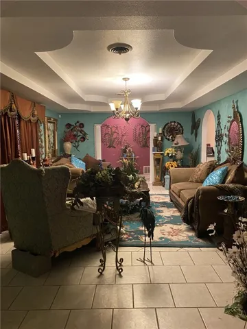 a living room with furniture and a chandelier