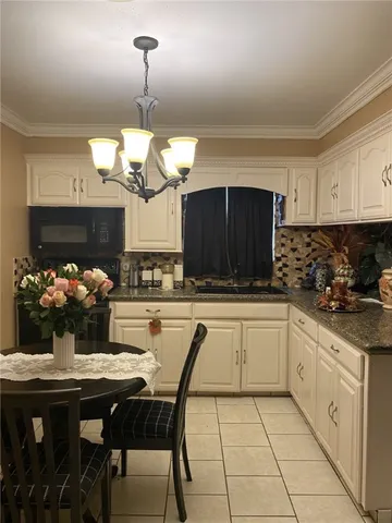 a kitchen with a dining table and chairs