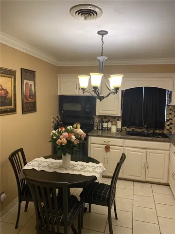 a kitchen with a table and chairs in it