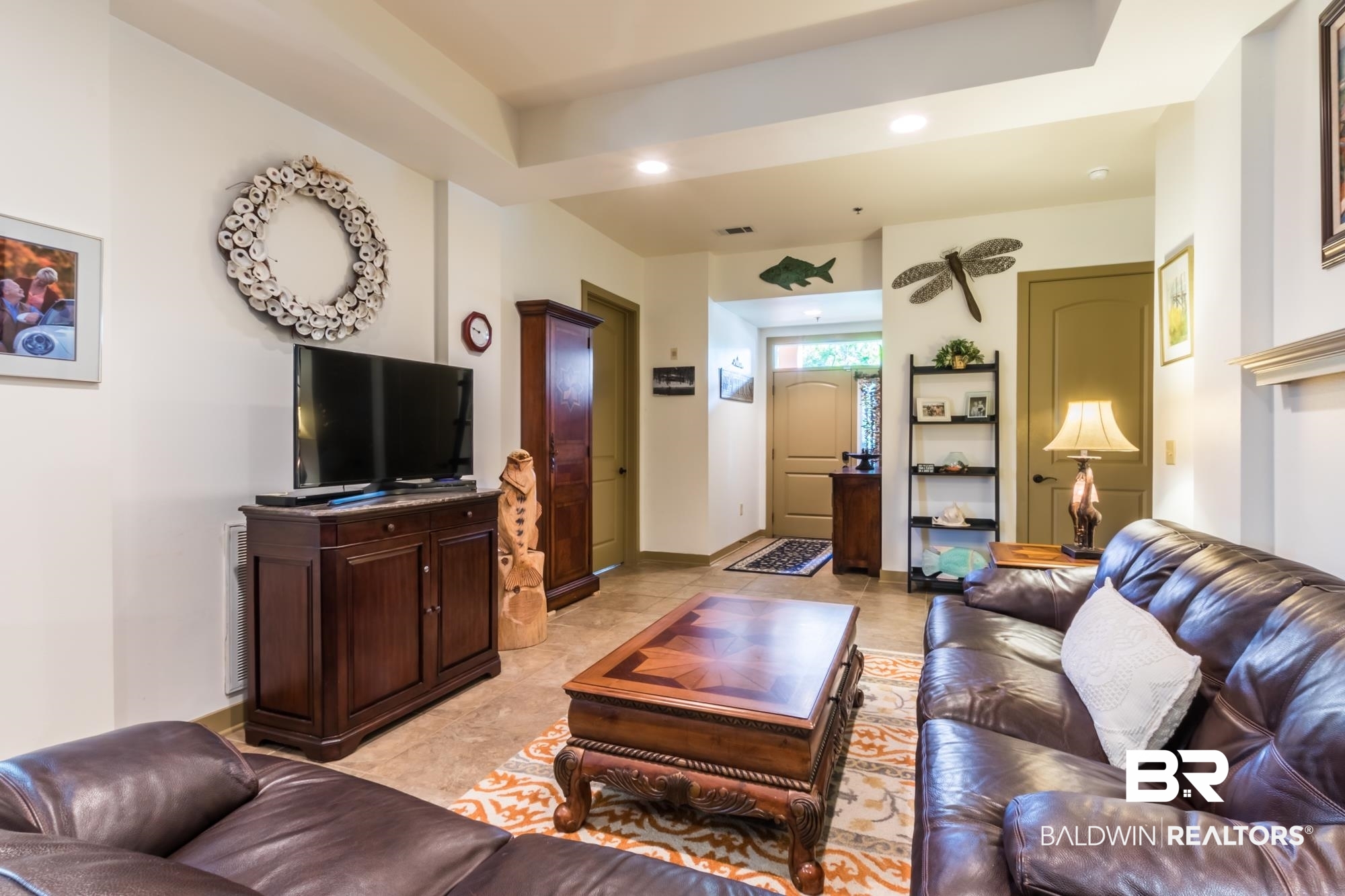 1430 Regency Road, Unit G103 Gulf Shores, AL 36542 - Photo 9 of 29 Tiled living room with a tray ceiling
