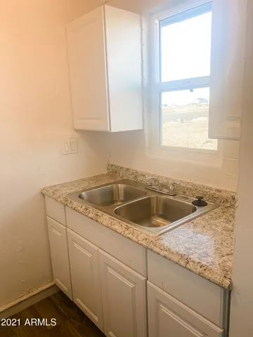 a view white cabinets and a sink