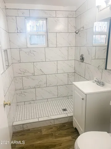 a bathroom with a sink toilet and shower