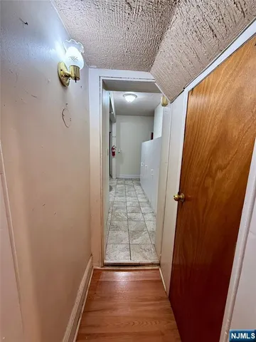 a view of a hallway view with wooden floor and staircase