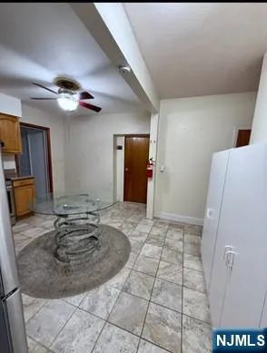a view of a livingroom with furniture and a ceiling fan