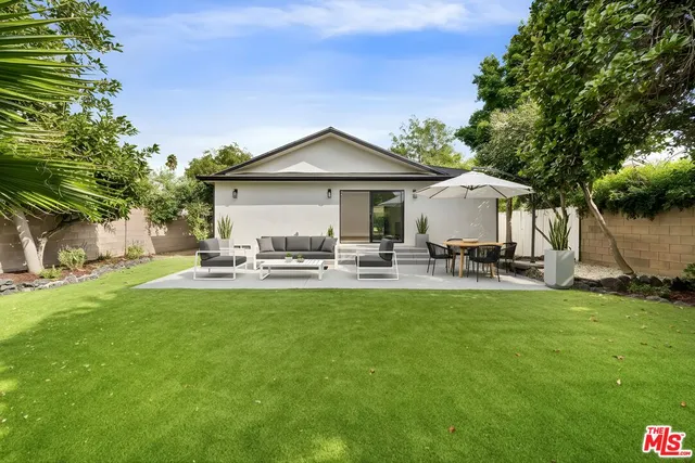 a view of a house with swimming pool and sitting area