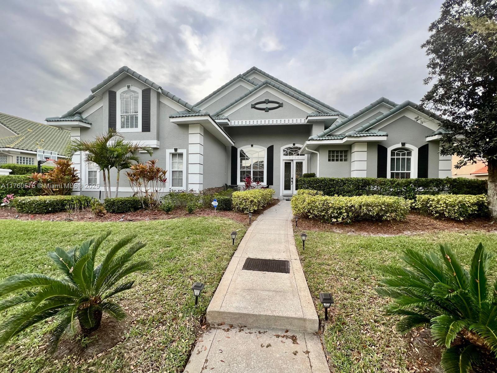 a front view of a house with a yard